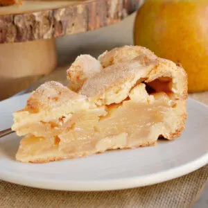 a slice of dutch apple tart on a white plate.