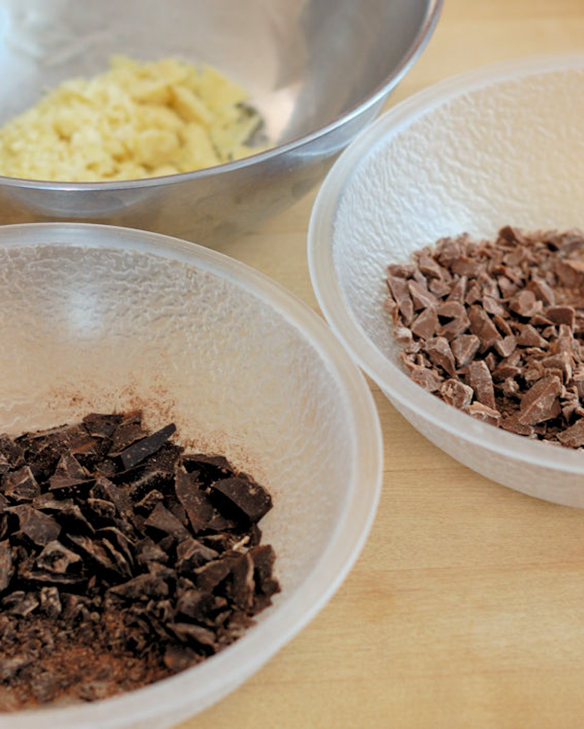 white, milk and dark chocolate in 3 separate bowls. 