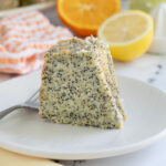 a slice of poppy seed cake on a white plate.