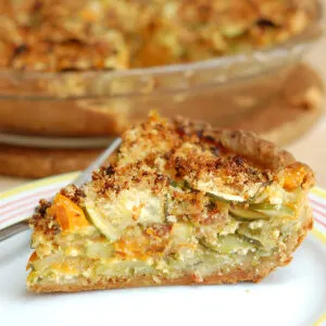 a slice of zucchini pie on a white plate.