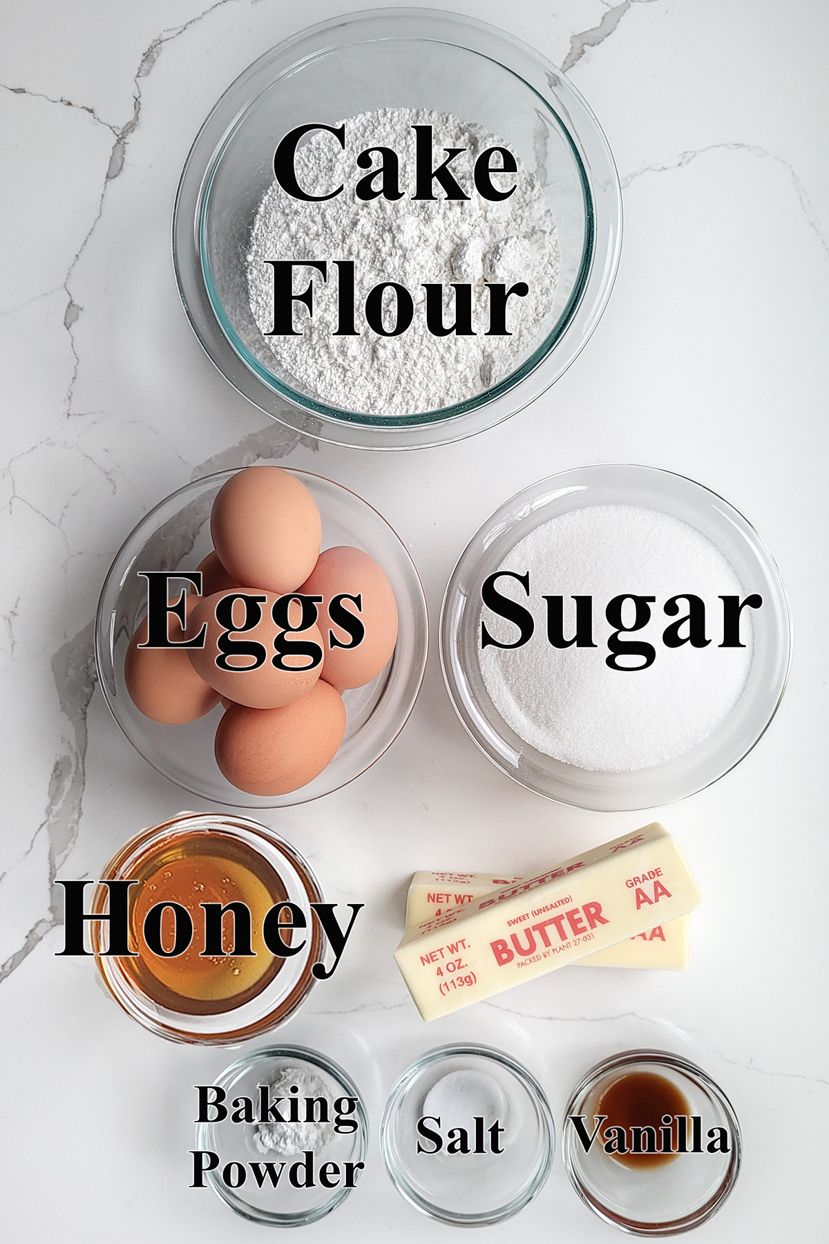 ingredients for honey pound cake in glass bowls.