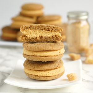 a stack of ginger pumpkin cookies on a white plate.