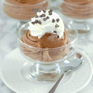 a bowl of chocolate mousse with a spoon.