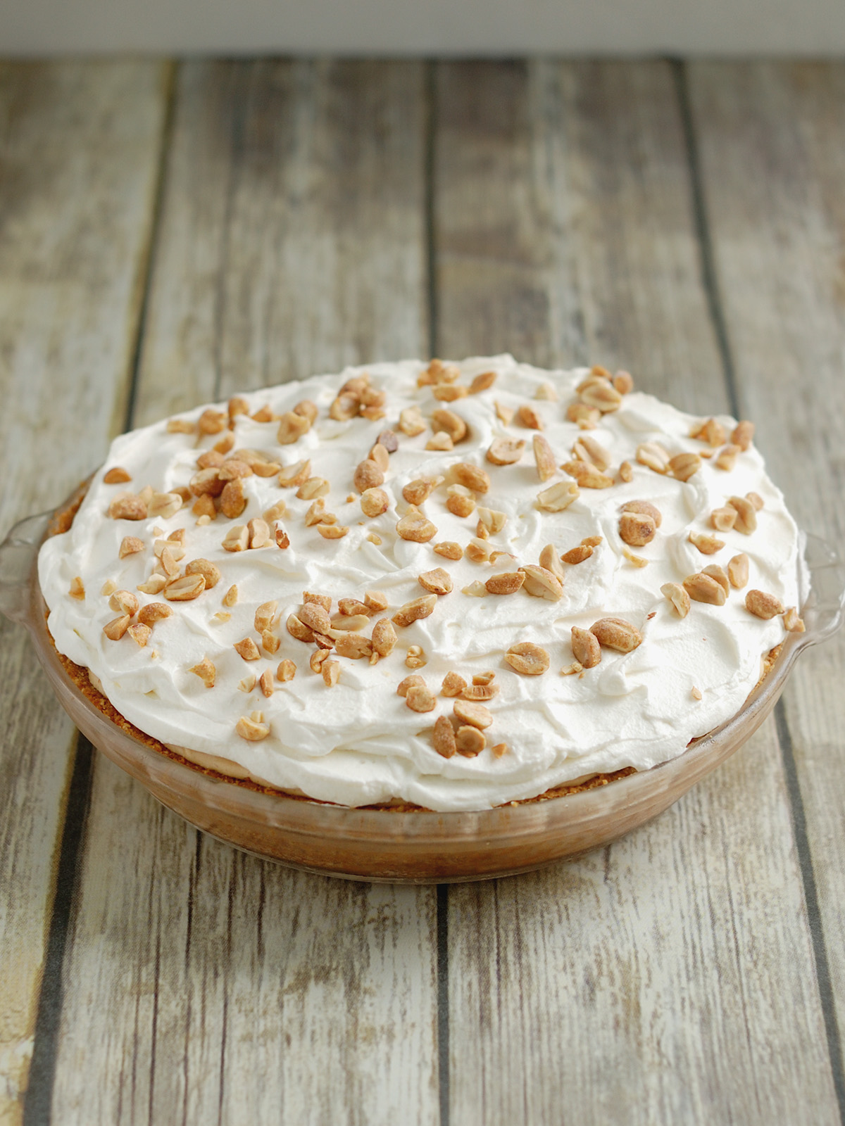 a peanut butter mousse pie on a wooden table.