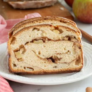 slices of apple cinnamon bread on a white plate.