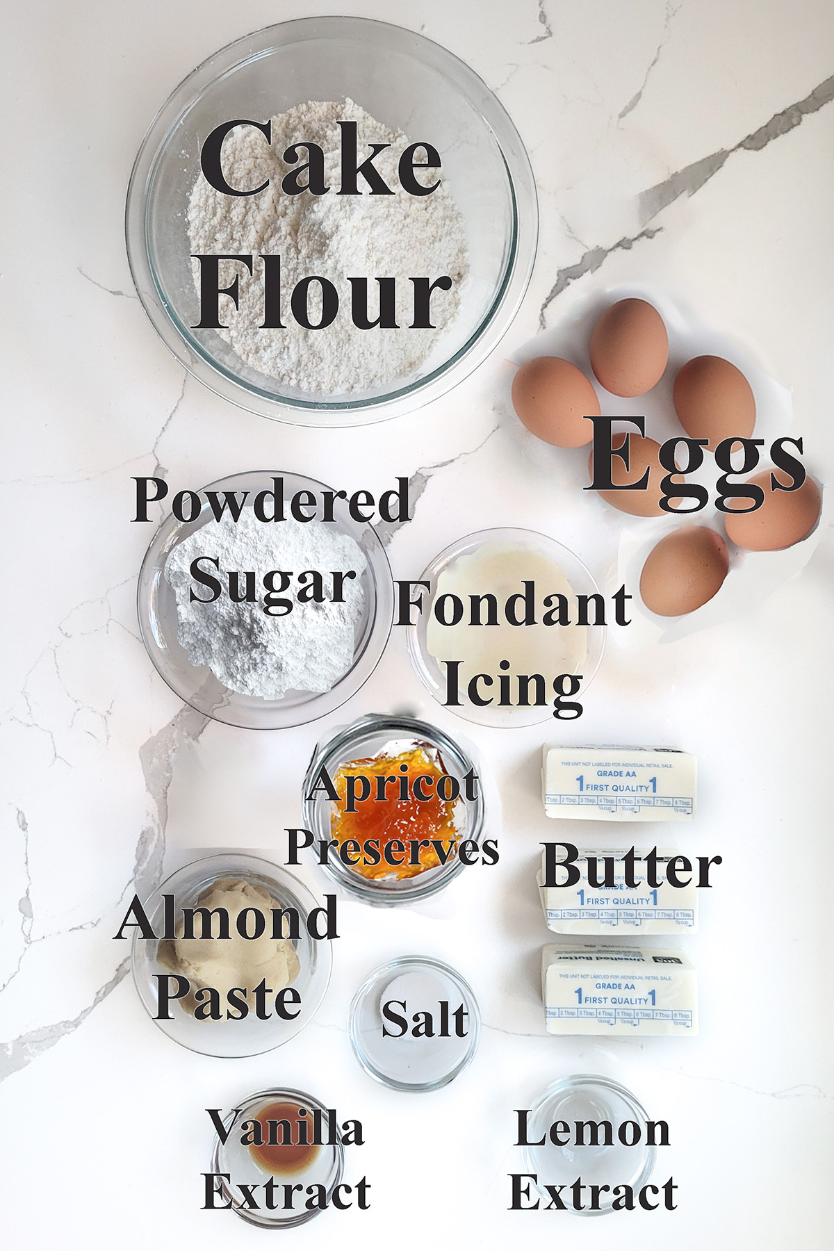 ingredients for petit fours in glass bowls on a white surface.