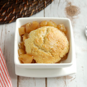 apple cobbler in a white bowl.