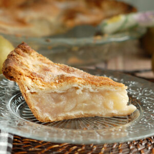 a slice of pear pie on a glass plate.