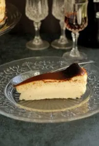 a slice of san sebastian cheesecake on a glass plate