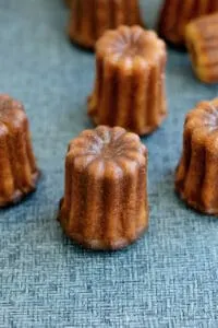 caneles on a blue surface