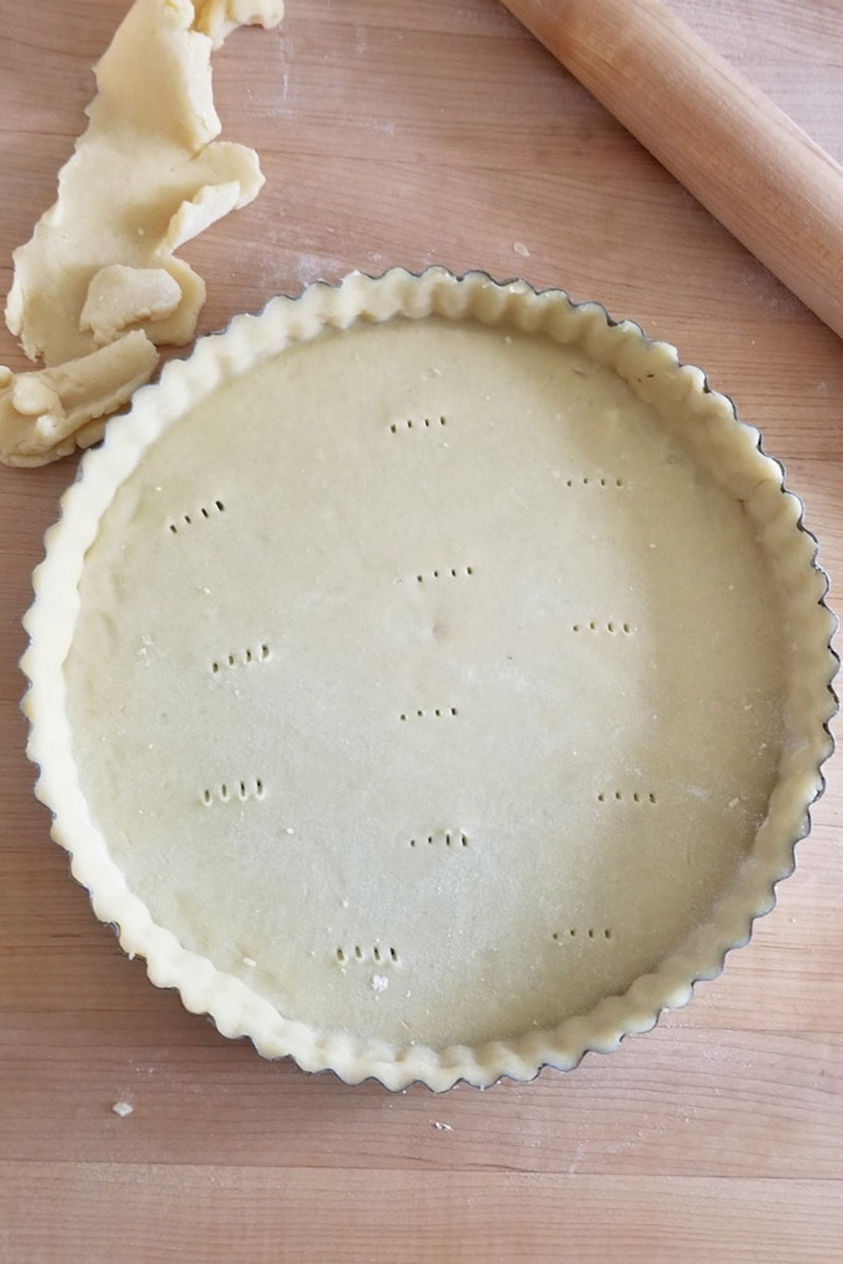 a tart pan filled with dough.