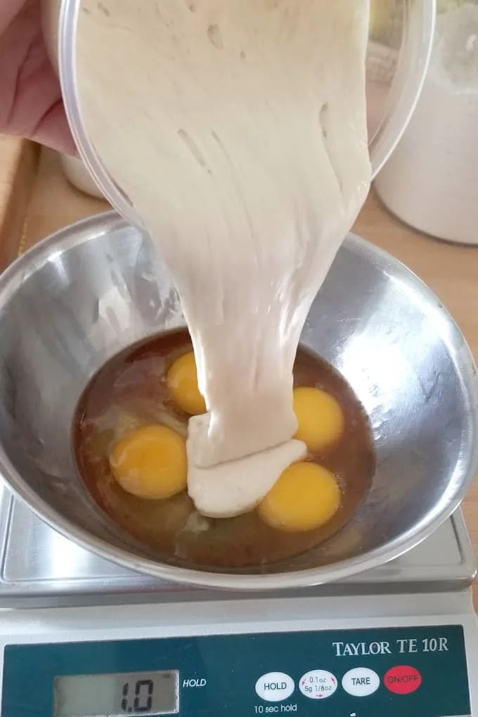 A photo showing sourdough discard being added to eggs and vanilla