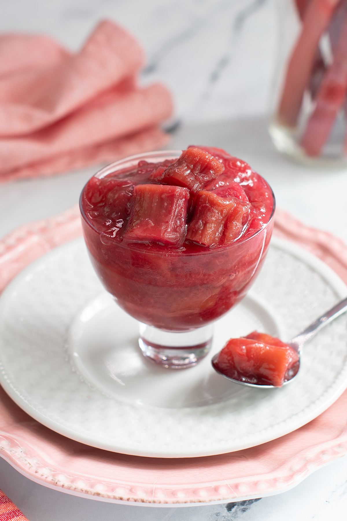 a glass bowl filled with rhubarb compote.