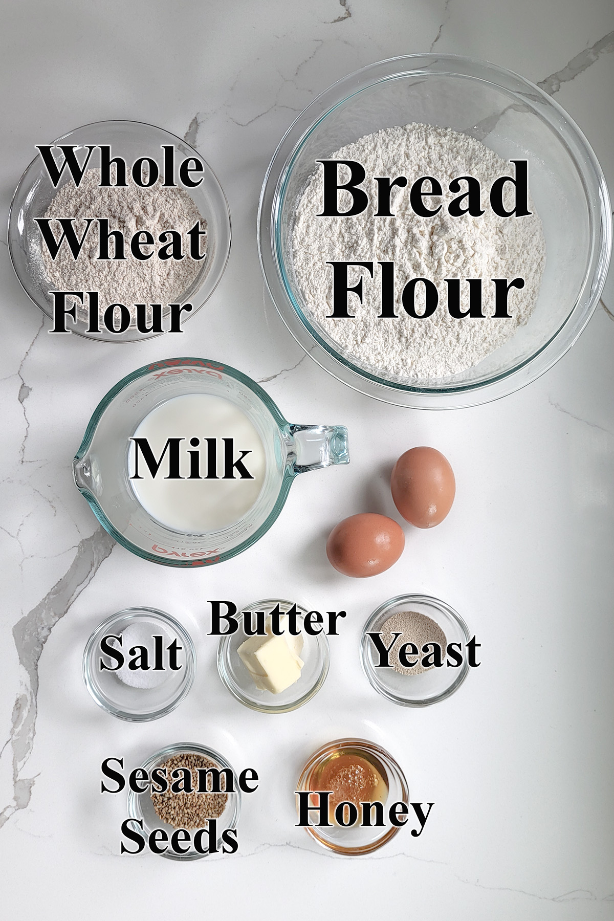 ingredients for whole wheat burger buns in glass bowls.