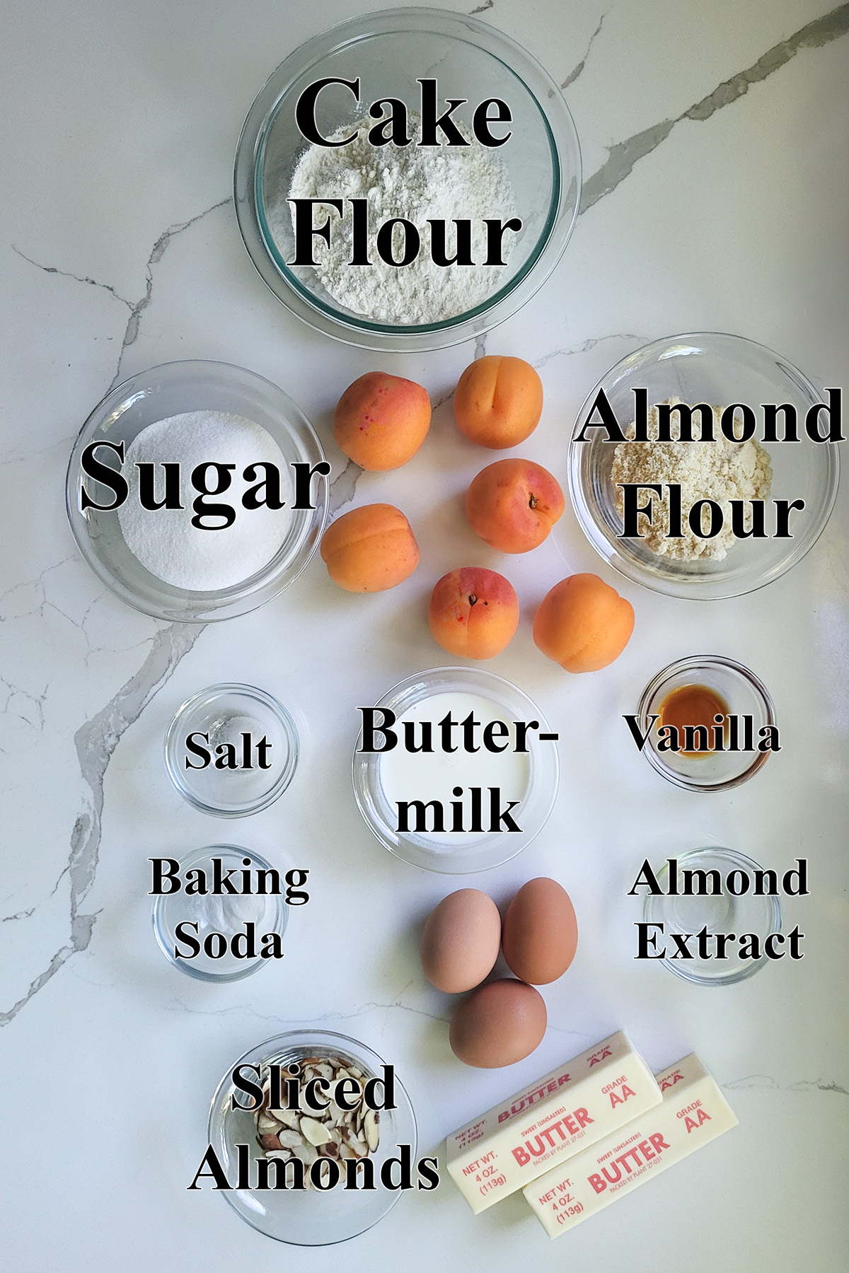 ingredients for apricot cake in glass bowls.