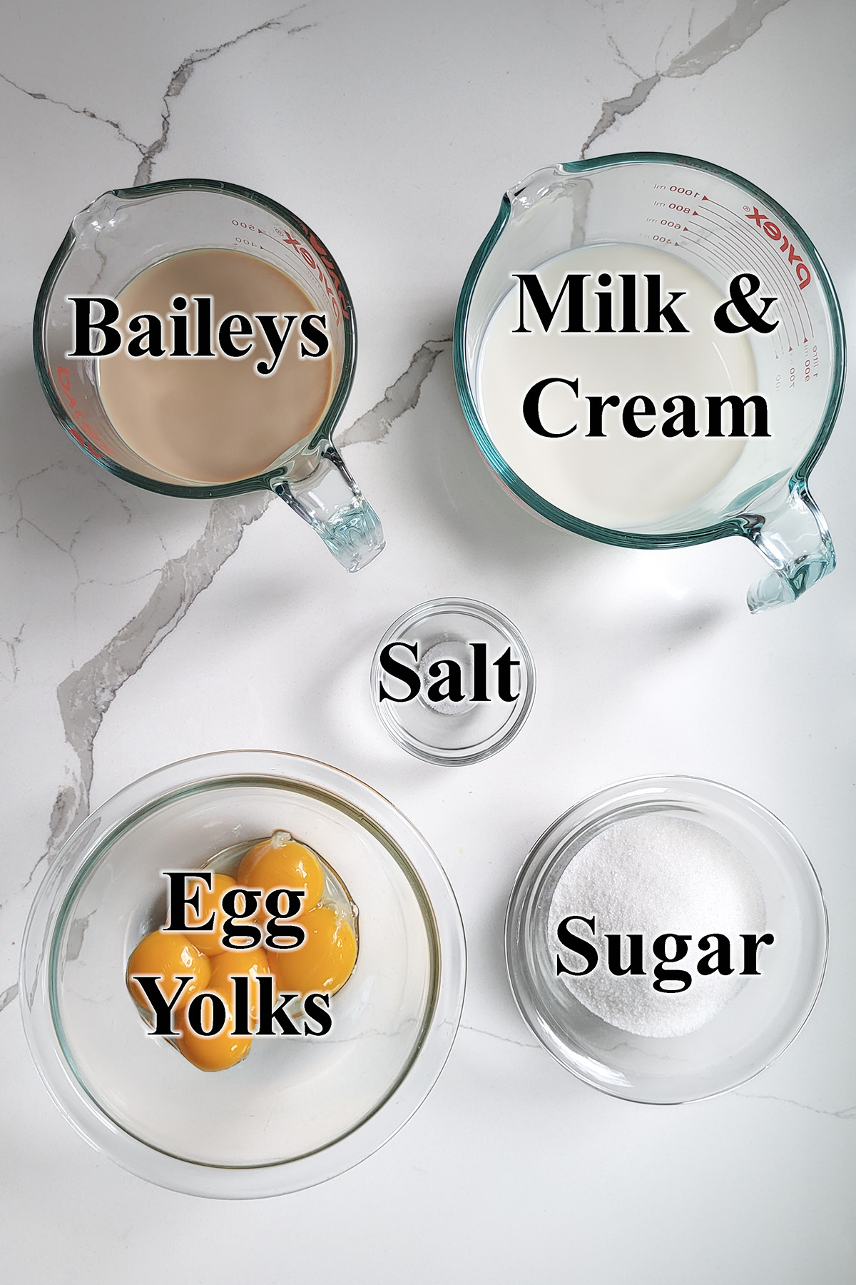 Ingredients for baileys ice cream in glass bowls.