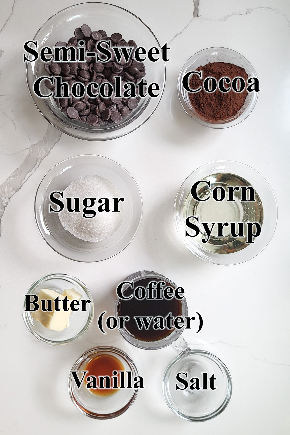 ingredients for hot fudge sauce in glass bowls.