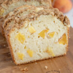 a sliced peach bread on a cutting board.