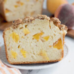 a slice of peach bread on a white plate.