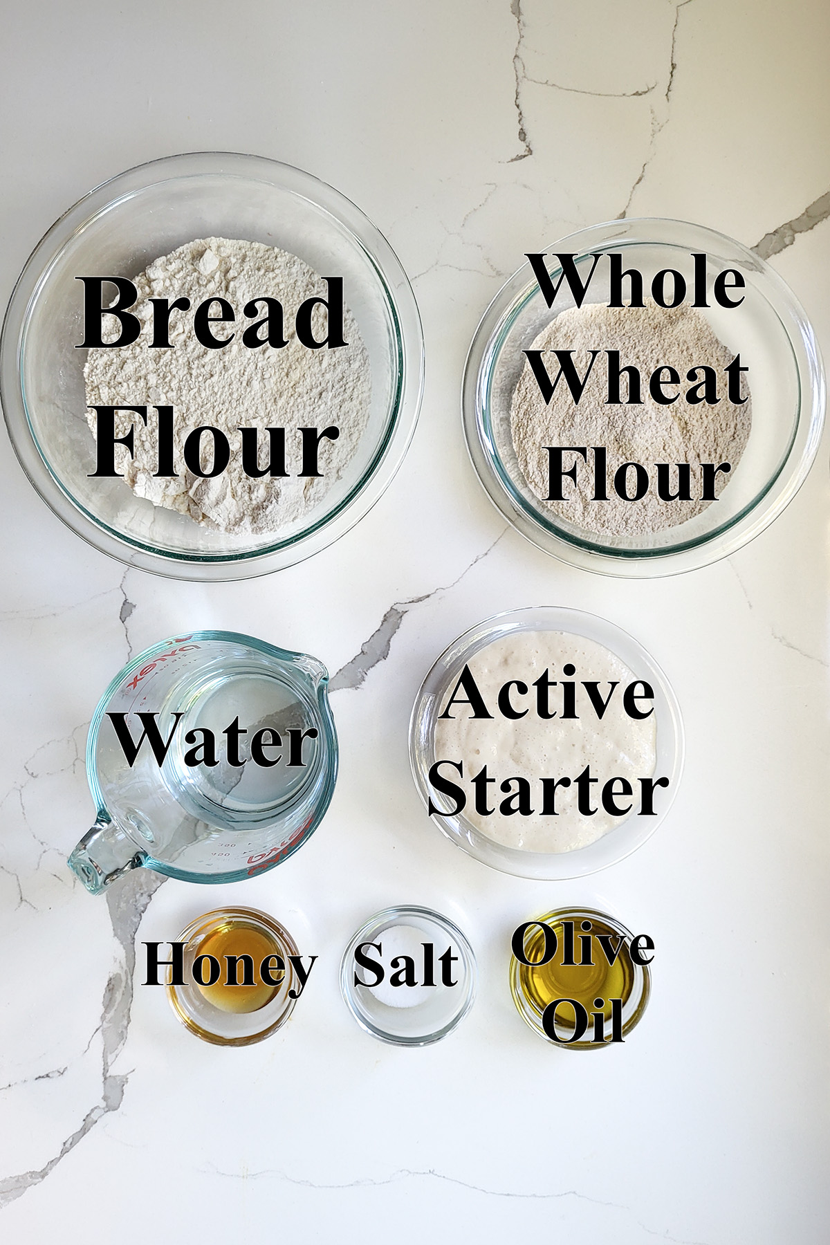 ingredients for sourdough whole wheat pit bread in glass bowls.