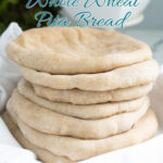 a pinterest image for sourdough whole wheat pita bread with text overlay.