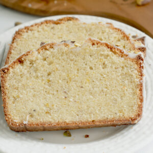 two slices of pistachio pound cake on a white plate.