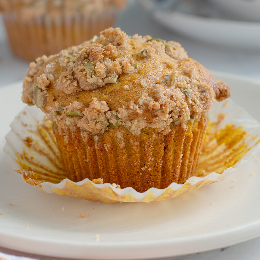 a pumpkin muffin on a white plate.