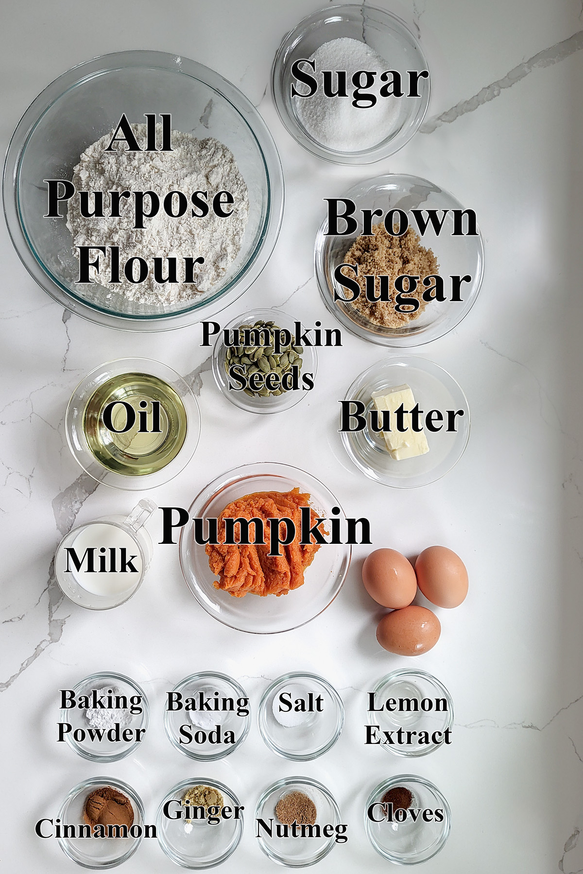 ingredients for pumpkin muffins in glass bowls.