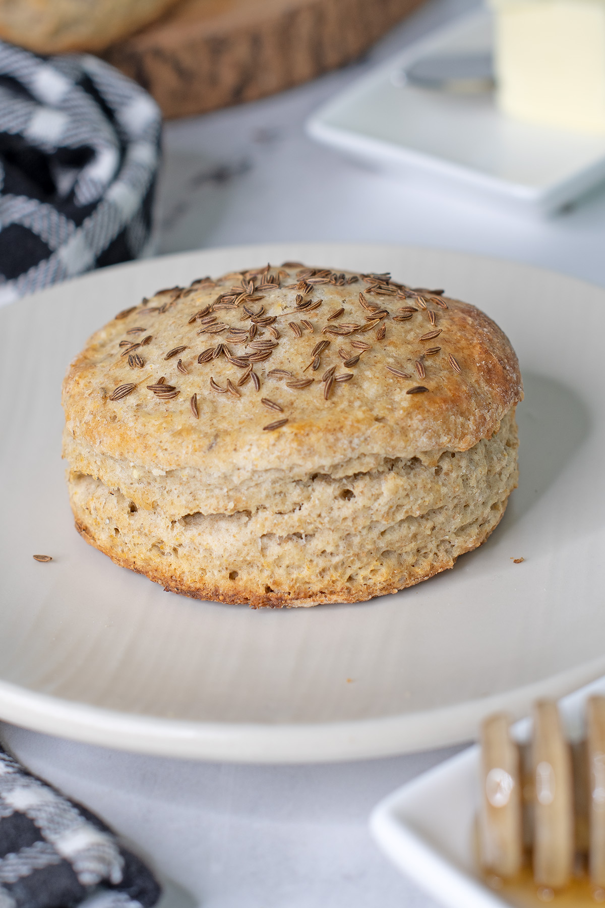 a rye scone on a white plate.