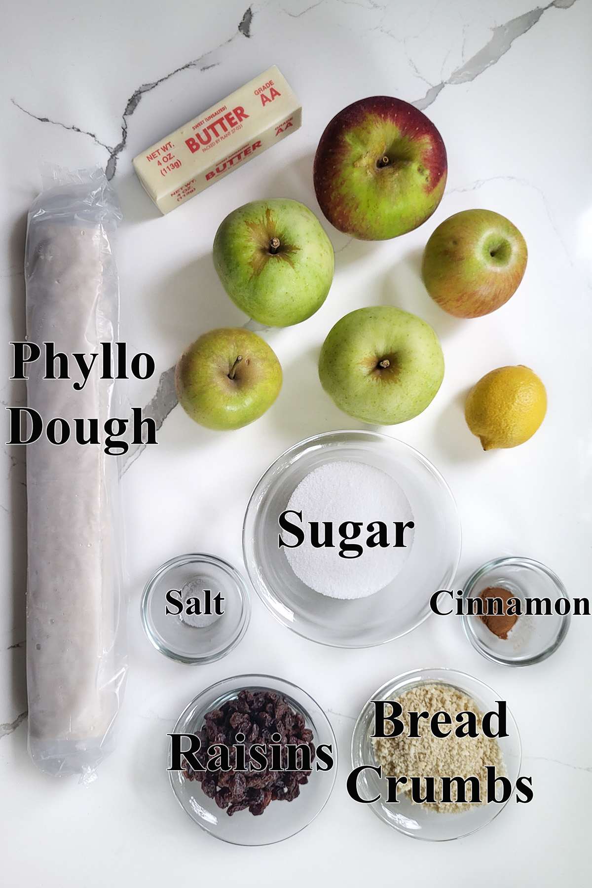 ingredients for apple strudel in glass bowls.