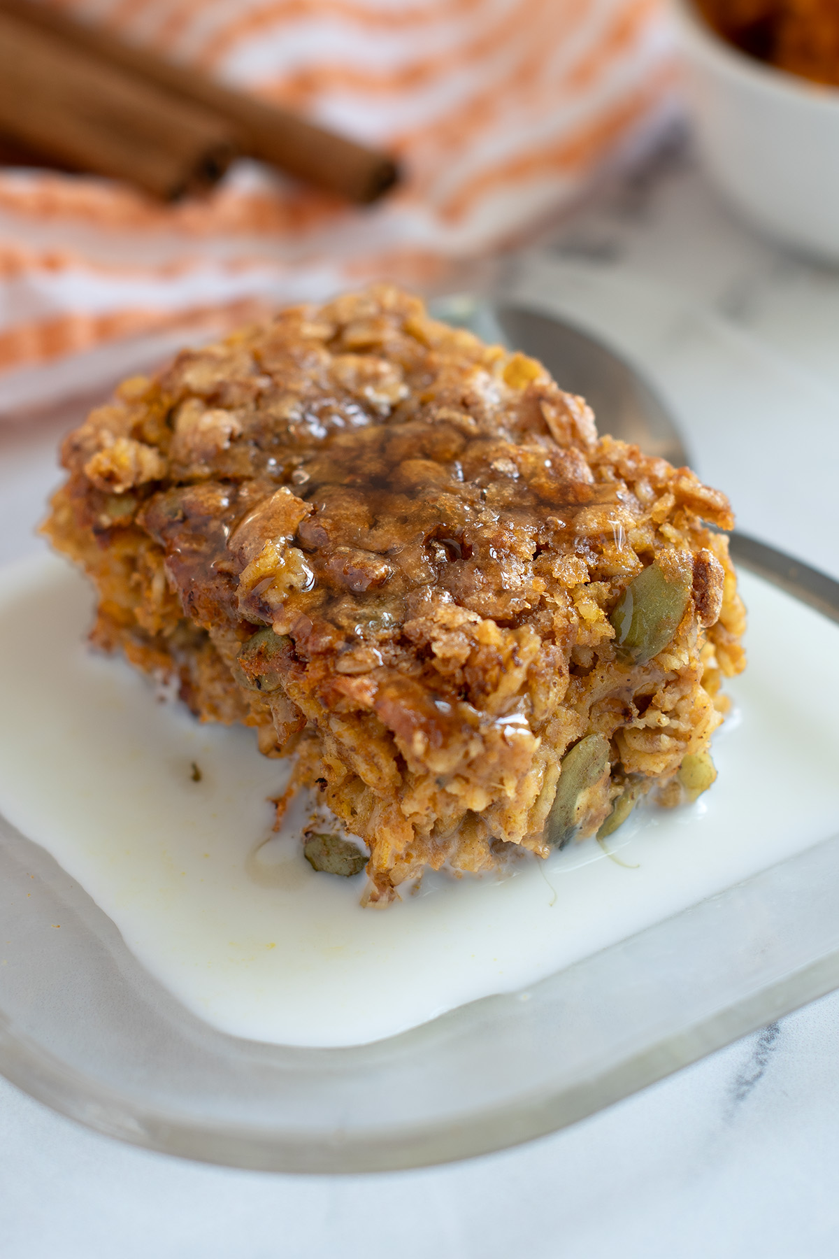 pumpkin baked oatmeal on a glass dish with milk. 