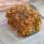 a piece of pumpkin baked oatmeal on a glass plate.