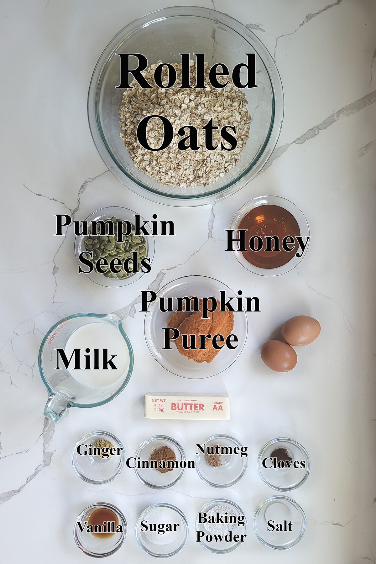 ingredients for pumpkin baked oatmeal in glass bowls.