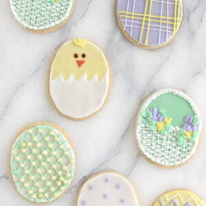 decorated sugar cookies on a marble surface.