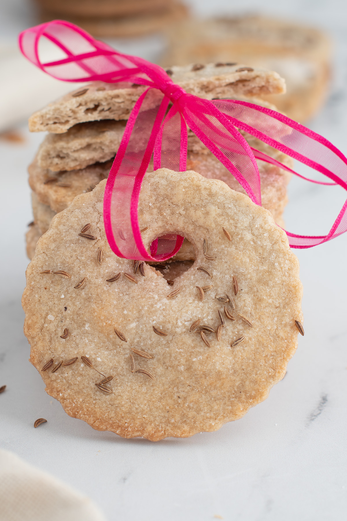 a rye cookie with a pink ribbon.