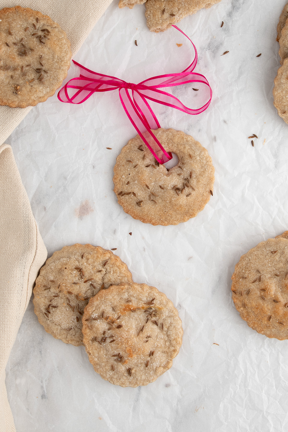 cookies on a white paper. One cookie with a pink ribbon.