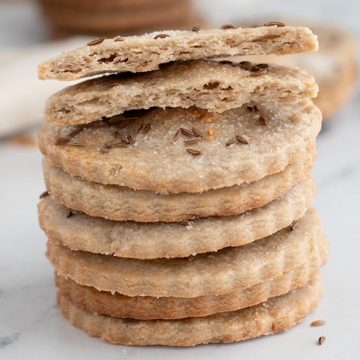 a stack of rye cookies on a white surface.