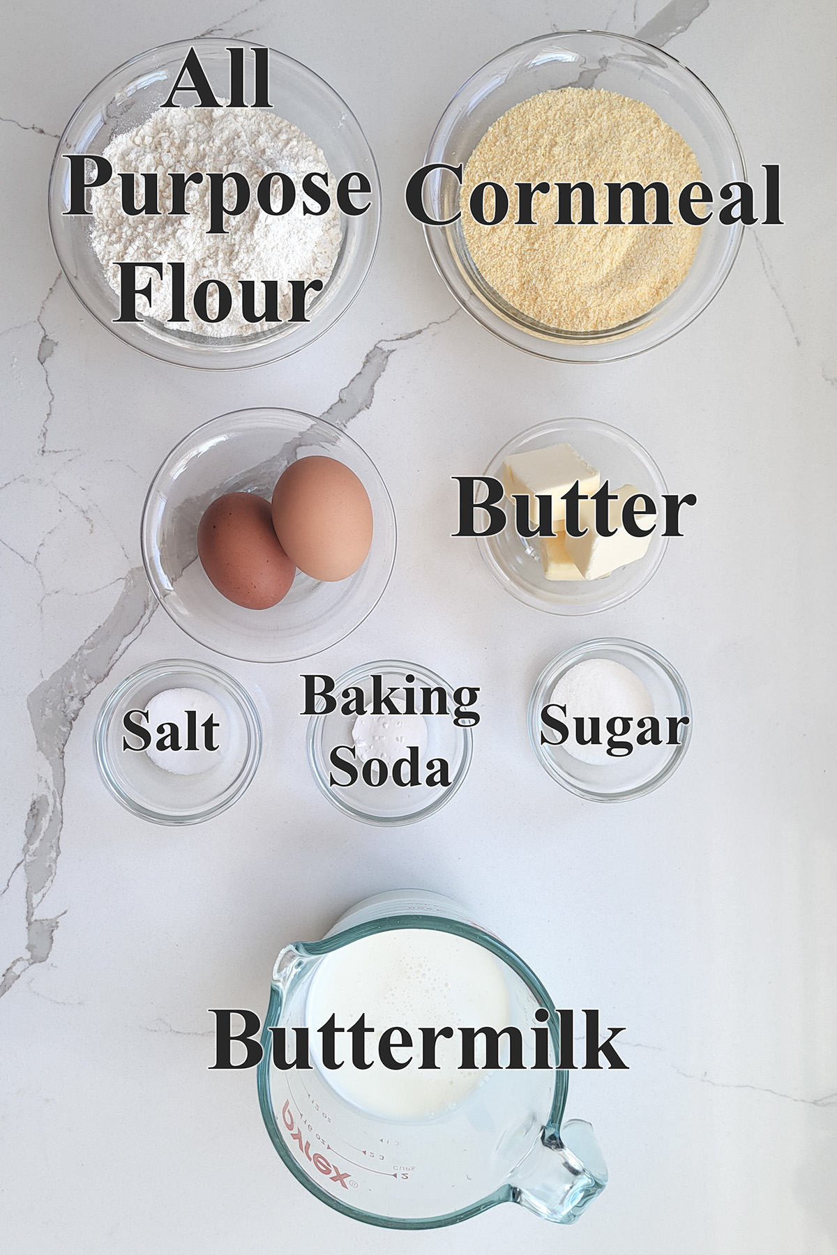 ingredients for cornbread in glass bowls.