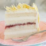 a pinterest image for white chocolate layer cake with text overlay.