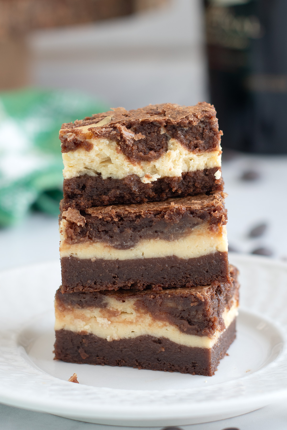 Three baileys brownies stacked on a white plate.
