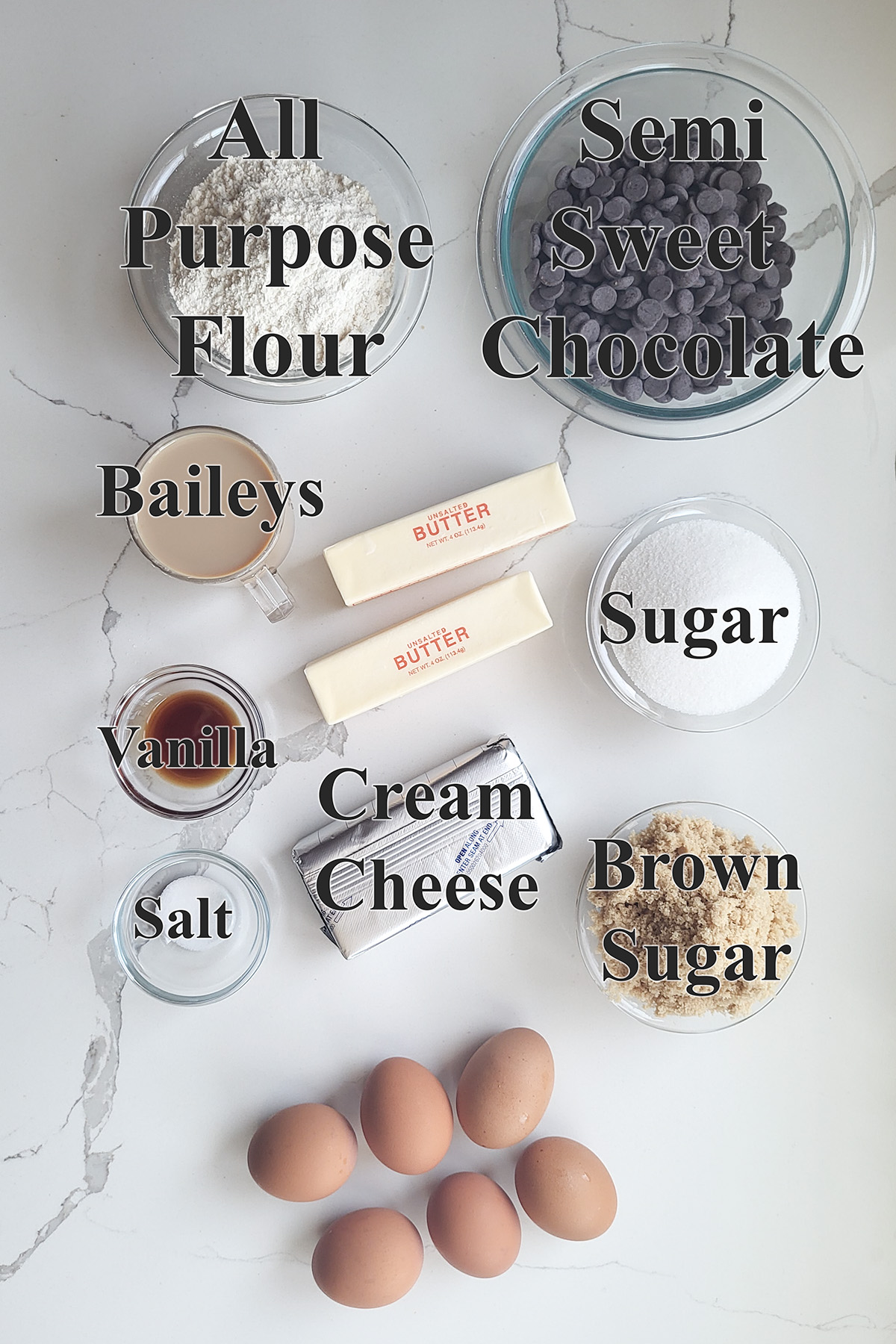 Ingredients For baileys brownies in glass bowls.